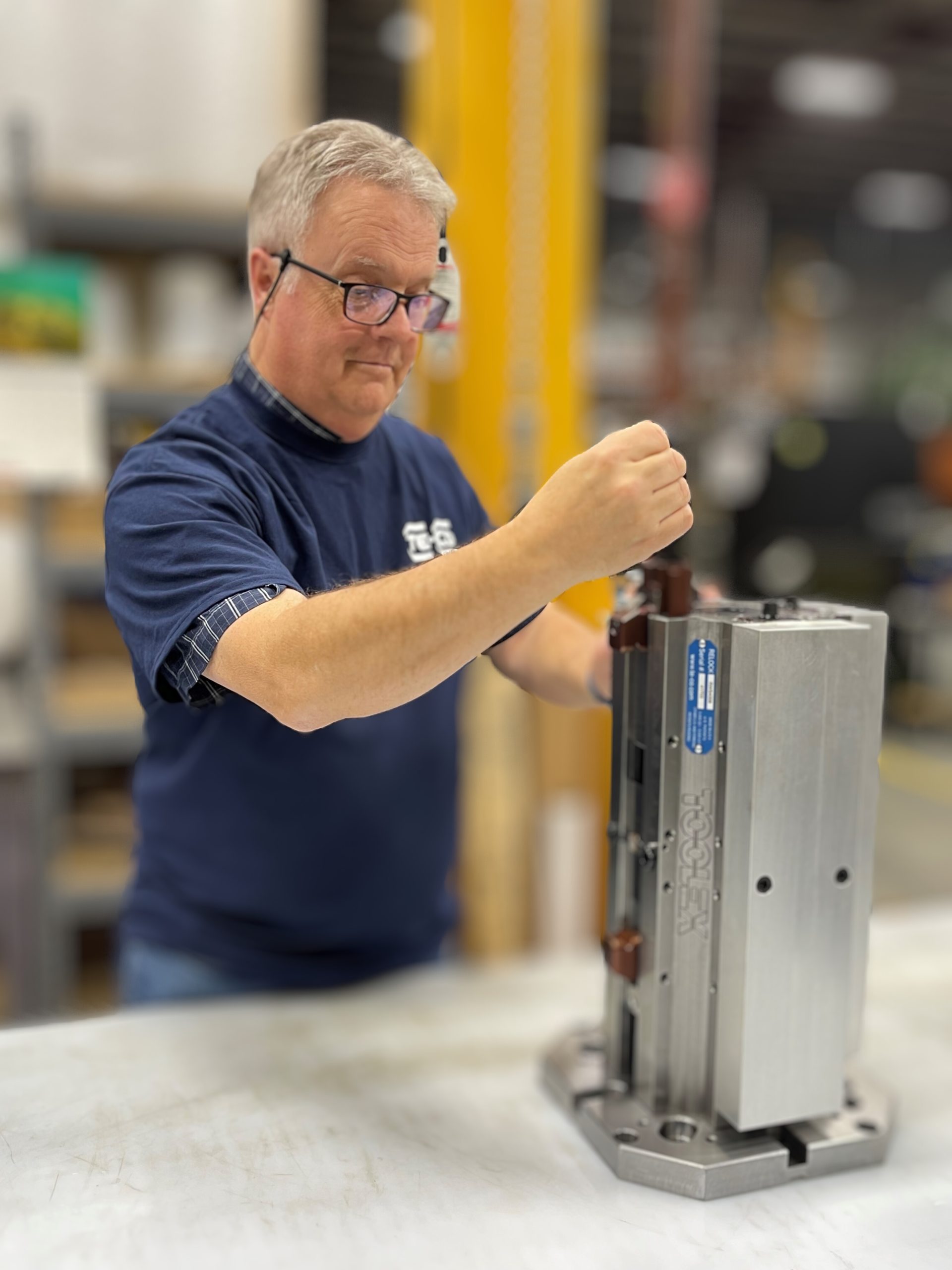 A man working on a quad vise