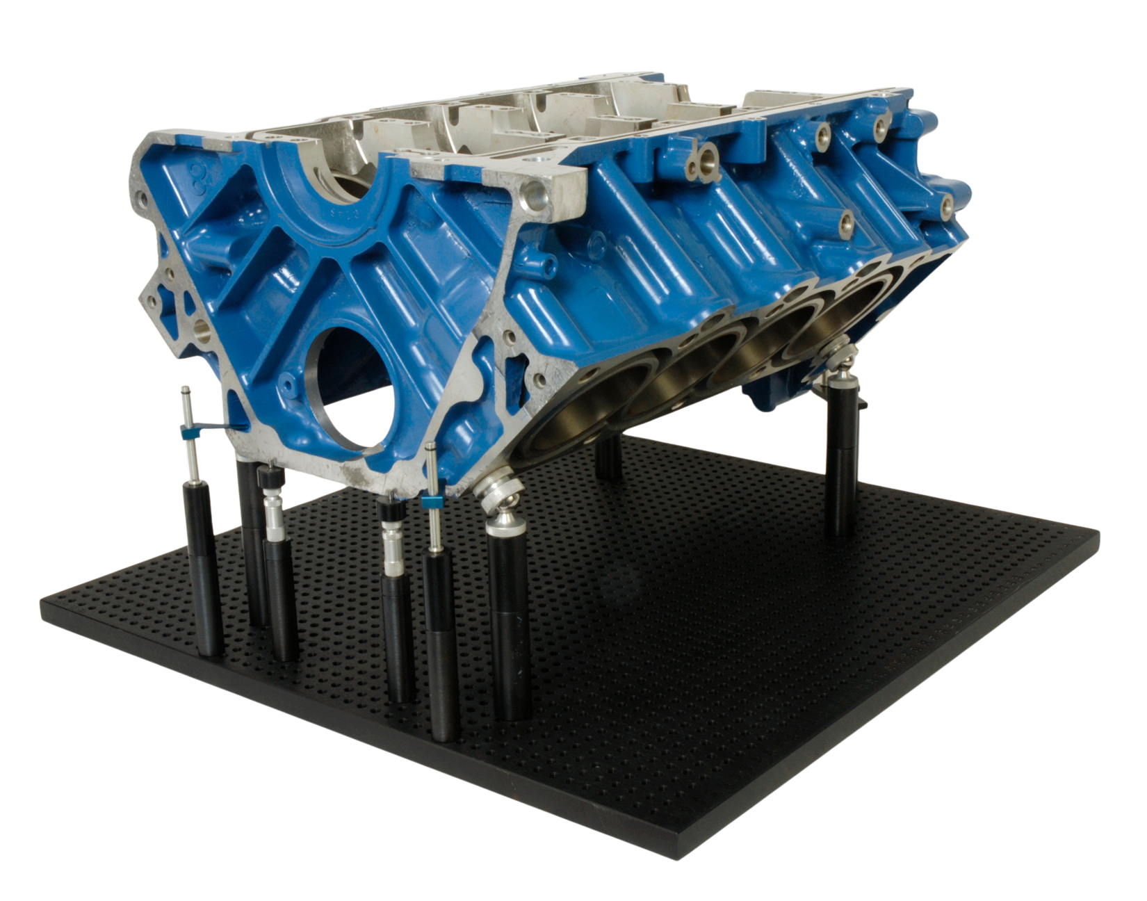 a blue and silver engine block is sitting on a black mat